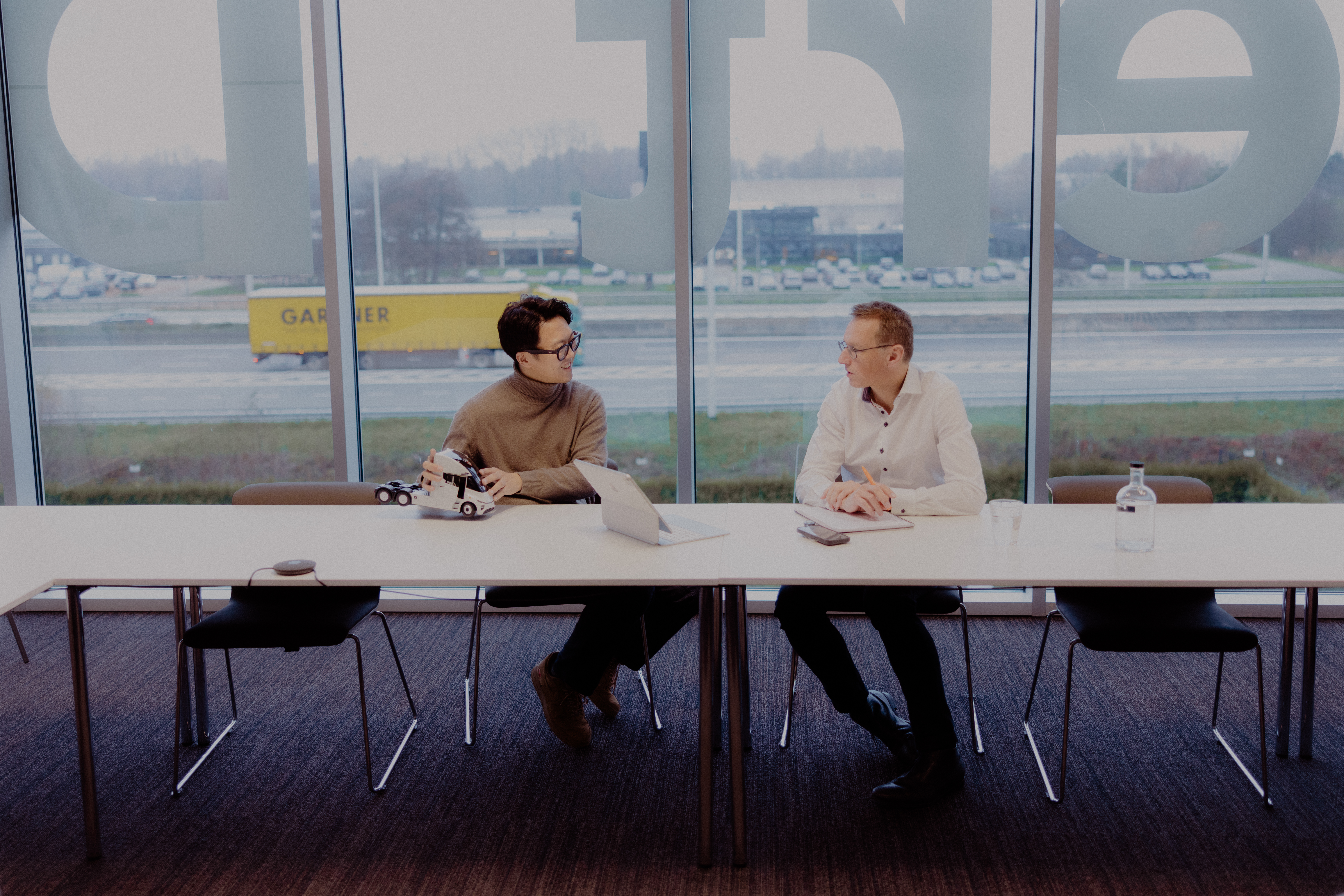 Windrose founder with Filip De Clercq, owner of GDC, discussing the E700 truck deal at GDC's Temse headquarters